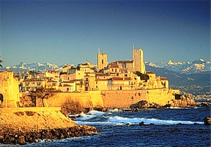 The Grimaldi Chateau and Antibes old Town rising above the beautiful Mediterranean with the French Alps as a backdrop